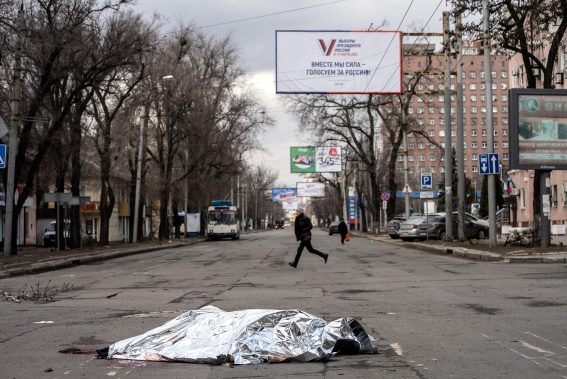 Il corpo di una donna ucraina giace sotto una coperta sulle strade di Donetsk